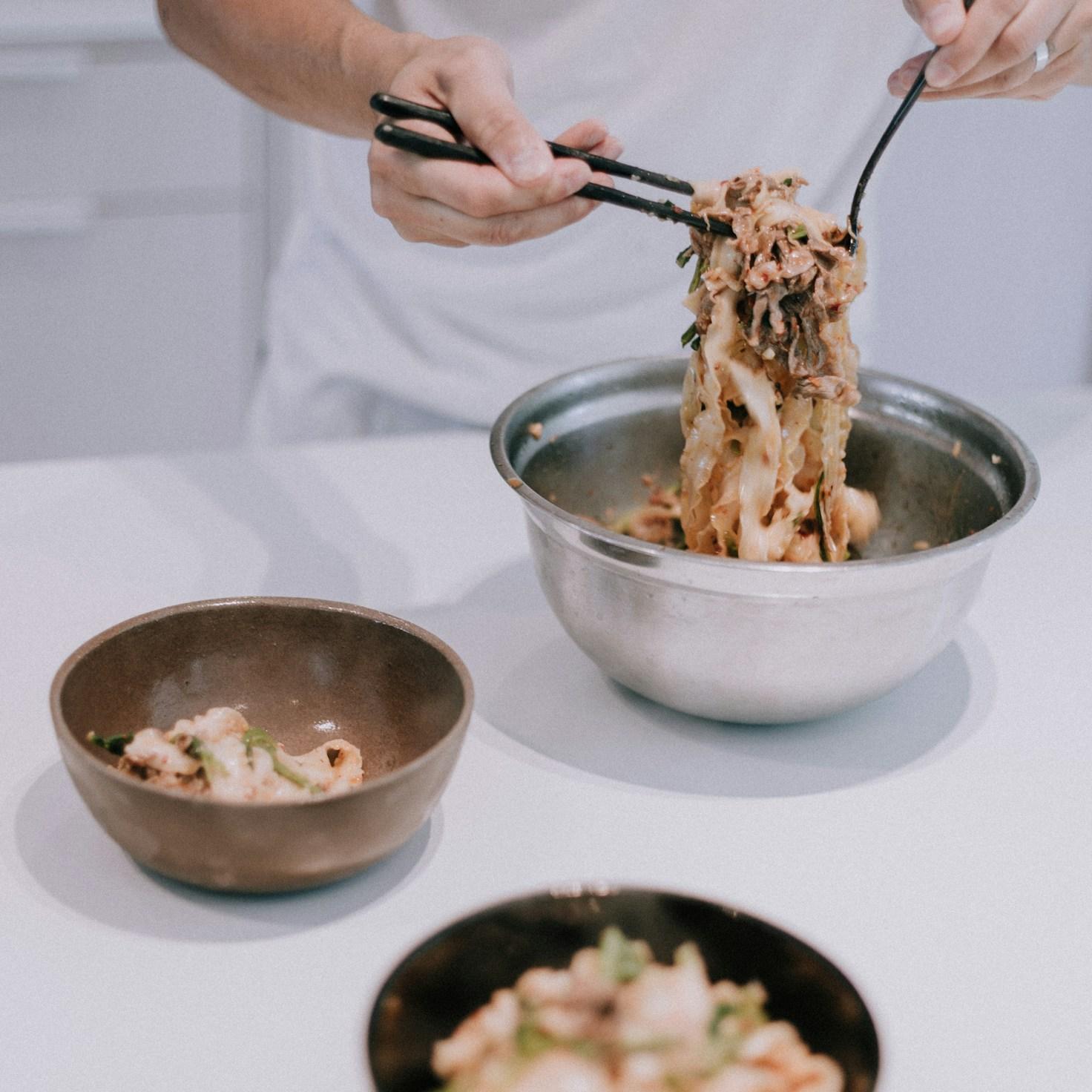 Community members collaborating in a modern kitchen space, sharing recipes and cooking techniques